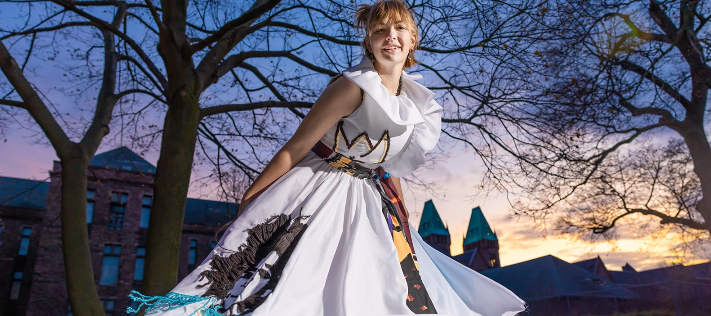 Student in a dress outside at sunset