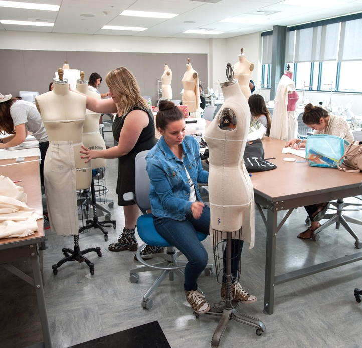 Students working on dress forms in class